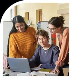 Team collaborating around laptop